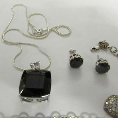 15 - A silver and onyx necklace and earrings together with a silver charm bracelet.