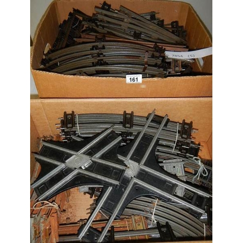 161 - Two boxes containing a quantity of two rail O gauge track including curves and straights.