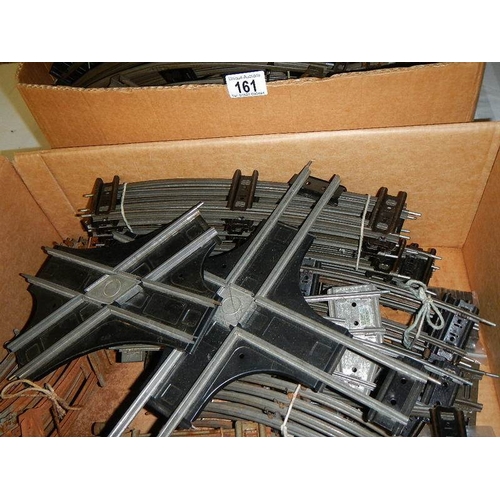 161 - Two boxes containing a quantity of two rail O gauge track including curves and straights.