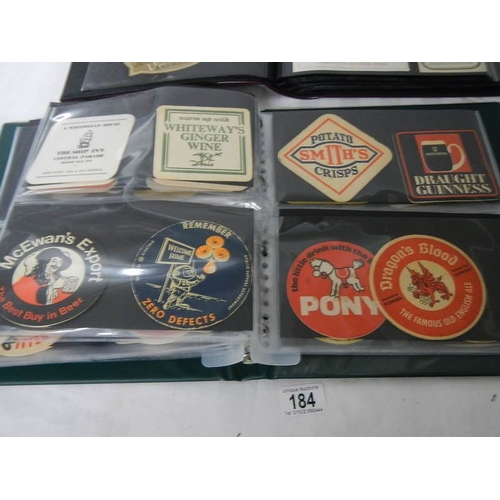 184 - 2 albums of whisky labels and mid 20th century beer mats.