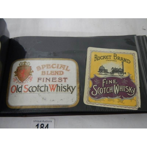 184 - 2 albums of whisky labels and mid 20th century beer mats.