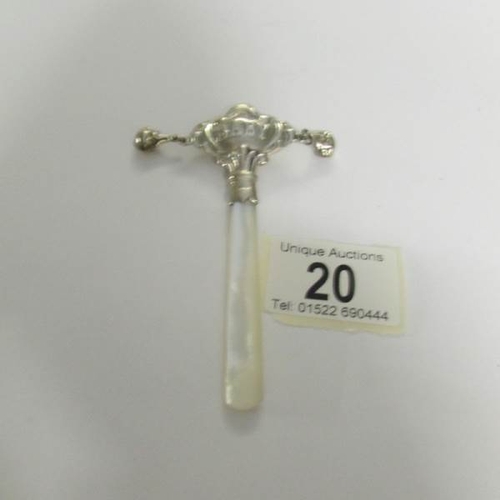 20 - A silver rattle with mother of pearl handle.