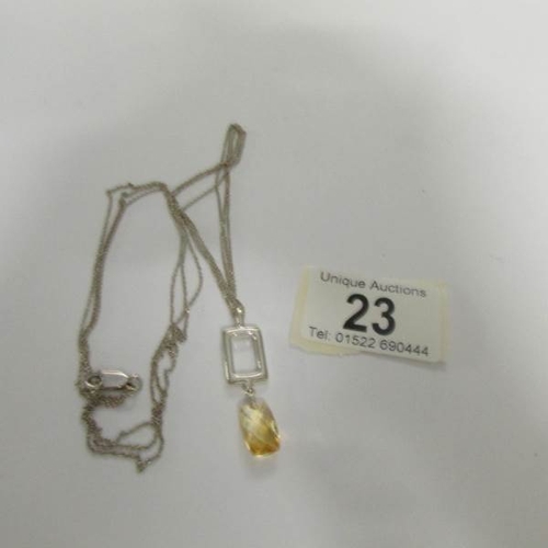 23 - A silver pendant on double chain.