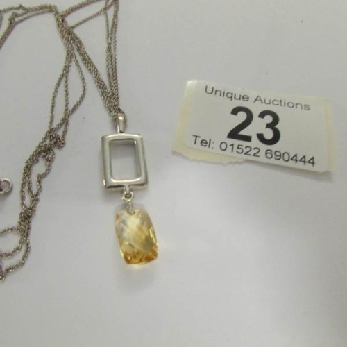 23 - A silver pendant on double chain.