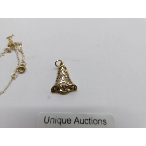 29 - A 9ct gold bell pendant and a finr 9ct gold chain (chain a/f), 1.4 grams.