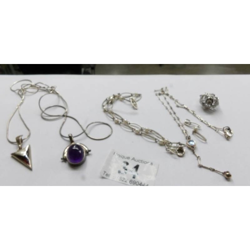 34 - 4 white metal necklaces and pendants including some silver.