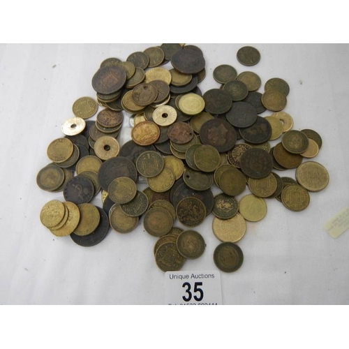 35 - A box of assorted coins including George III, Victorian gaming tokens etc.,