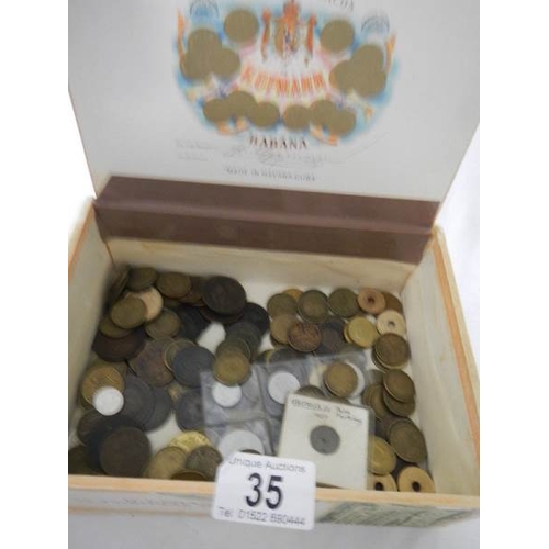 35 - A box of assorted coins including George III, Victorian gaming tokens etc.,