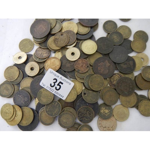 35 - A box of assorted coins including George III, Victorian gaming tokens etc.,