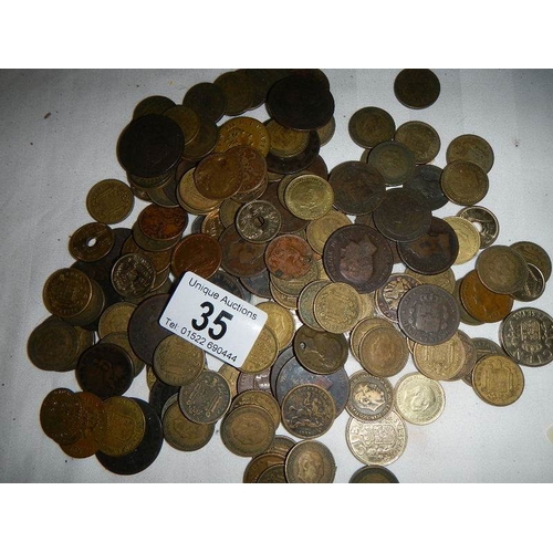 35 - A box of assorted coins including George III, Victorian gaming tokens etc.,