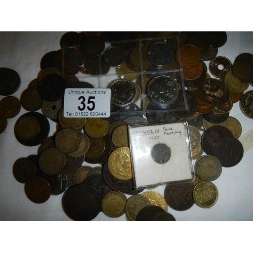 35 - A box of assorted coins including George III, Victorian gaming tokens etc.,