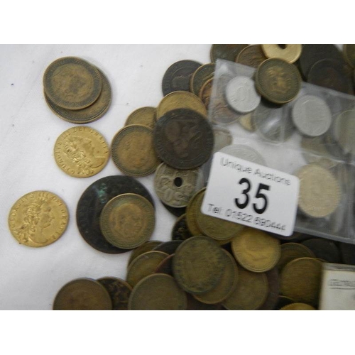 35 - A box of assorted coins including George III, Victorian gaming tokens etc.,