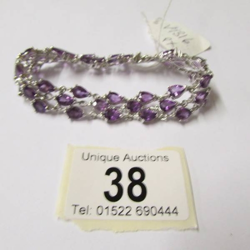 38 - An amethyst bracelet - 39 amethysts set in silver.