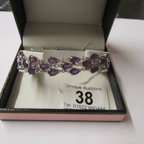 38 - An amethyst bracelet - 39 amethysts set in silver.