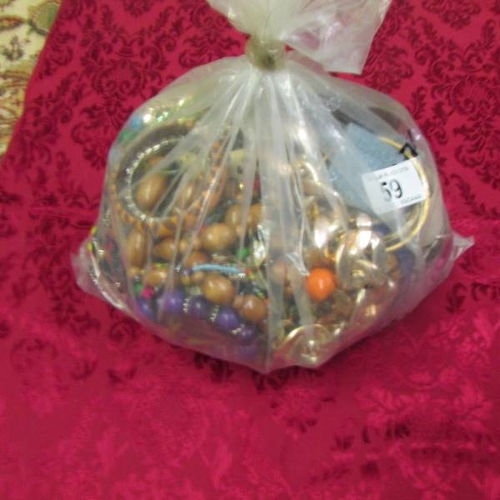 59 - A bag of mixed costume jewellery, approximately 3.5 kg.