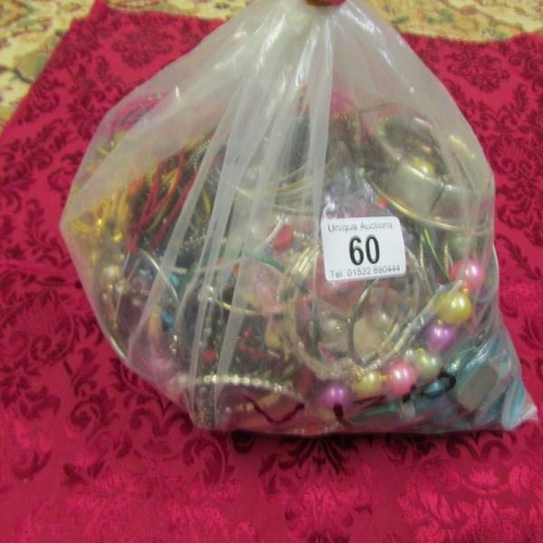 60 - A bag of mixed costume jewellery, approximately 3.5 kg.