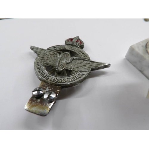 100 - A 1950's Civil Service Motoring association car badge and a racing car trophy.