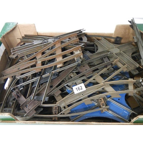 162 - A box containing a quantity of two rail O gauge track including various junction points.