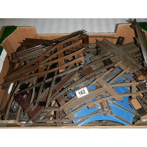 162 - A box containing a quantity of two rail O gauge track including various junction points.