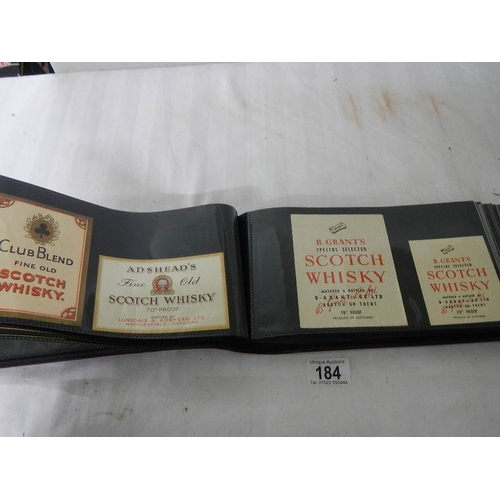 184 - 2 albums of whisky labels and mid 20th century beer mats.