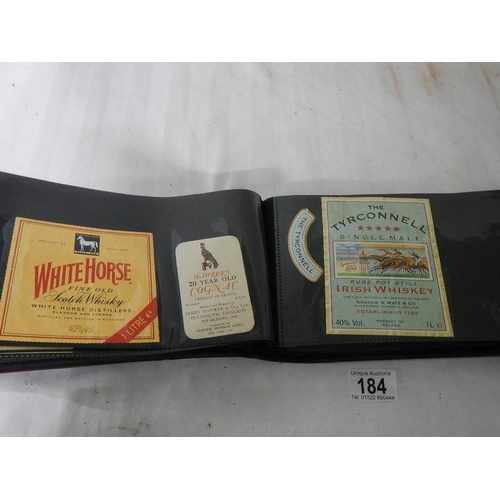 184 - 2 albums of whisky labels and mid 20th century beer mats.