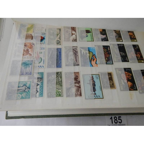 185 - A good collection of Spanish stamps in 5 albums plus reference books.