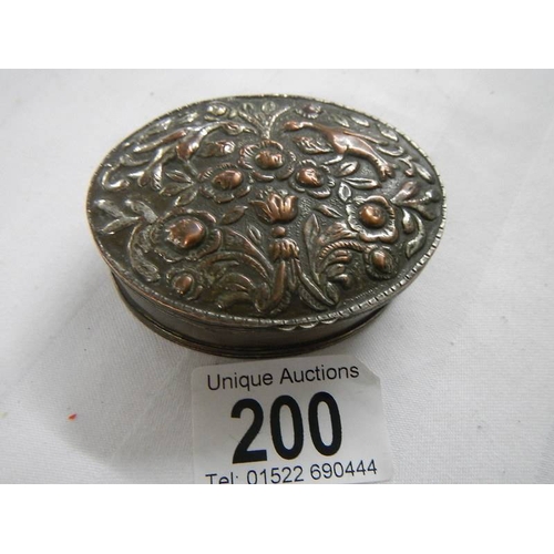 200 - An old silver plate on copper snuff box with embellished top.