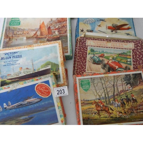 203 - A quantity of vintage wooden jigsaw puzzles.