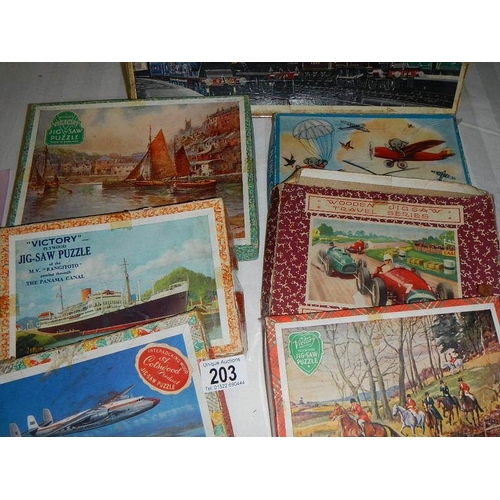 203 - A quantity of vintage wooden jigsaw puzzles.