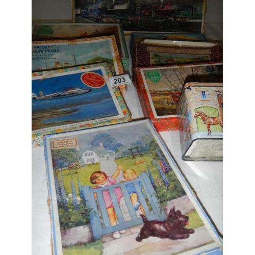 203 - A quantity of vintage wooden jigsaw puzzles.