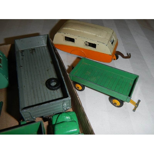 210 - A mixed lot of Dinky caravans, trailers and farm implements etc.,