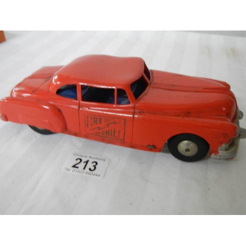 213 - A Triang tinplate clockwork Ford Zephyr, a Plastic friction fire chief car and an express van.