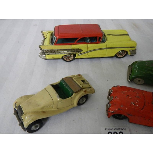 233 - 2 tinplate Scalex friction cars, a Bandai American estate car and one other.