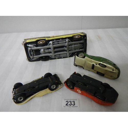 233 - 2 tinplate Scalex friction cars, a Bandai American estate car and one other.