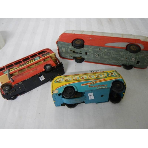 234 - A Triang Minic clockwork bus (working) and 2 Mettoy friction coaches.