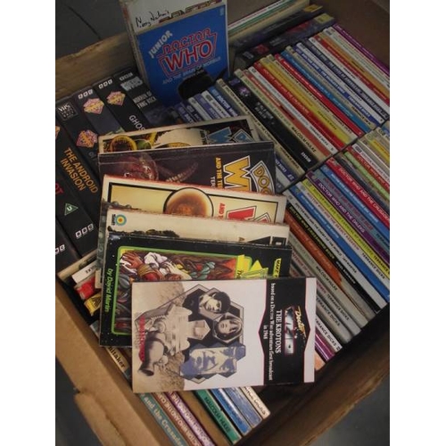 302 - 4 boxes of Doctor Who books. jigsaws, magazines etc.,