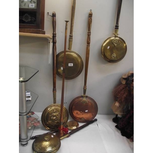 316 - 6 brass and copper bed warming pans and a copper post horn.