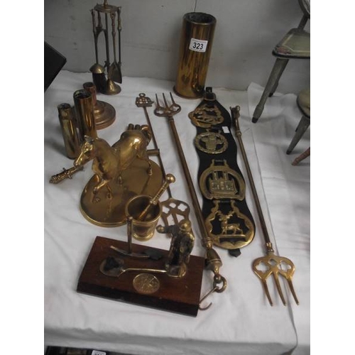 323 - A mixed lot of brass ware including shell cases, toasting forks, horse etc.,