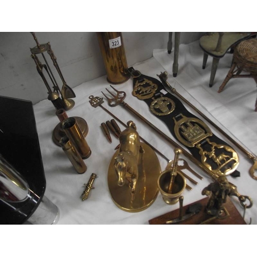 323 - A mixed lot of brass ware including shell cases, toasting forks, horse etc.,