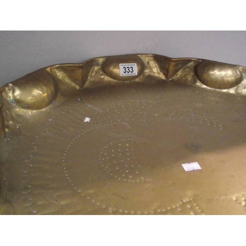 333 - An Eastern brass tray table with folding base.