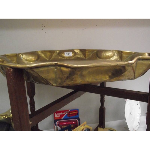 333 - An Eastern brass tray table with folding base.