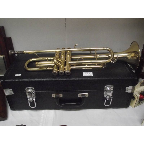 335 - A cased brass trumpet, not named.