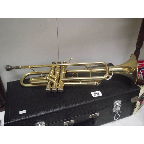 335 - A cased brass trumpet, not named.