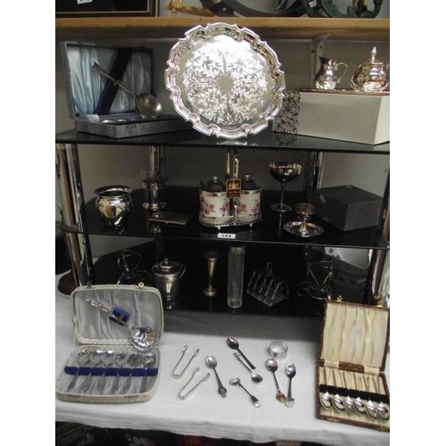 344 - 4 shelves of assorted chrome and silver plate including cutlery, tray, condiment sets etc.,