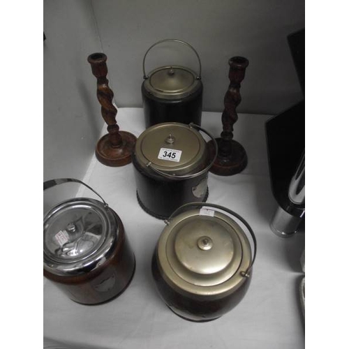 345 - 4 oak biscuit barrels and a pair of barley twist candlesticks.