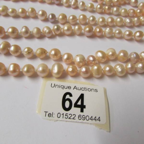 64 - A one hundred inch long genuine pearl necklace.