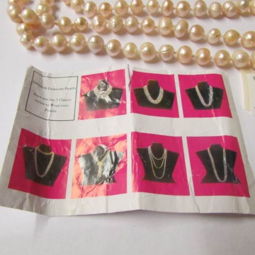 64 - A one hundred inch long genuine pearl necklace.