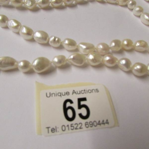 65 - A thirty eight inch long pearl necklace.