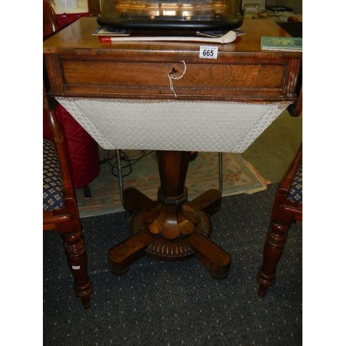 665 - A Victorian figured rosewood sewing table.