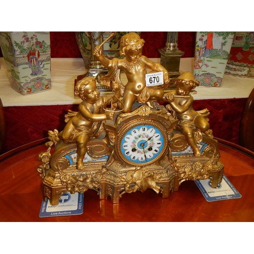 670 - A good French spelter mantle clock with porcelain panels.  In good working order.